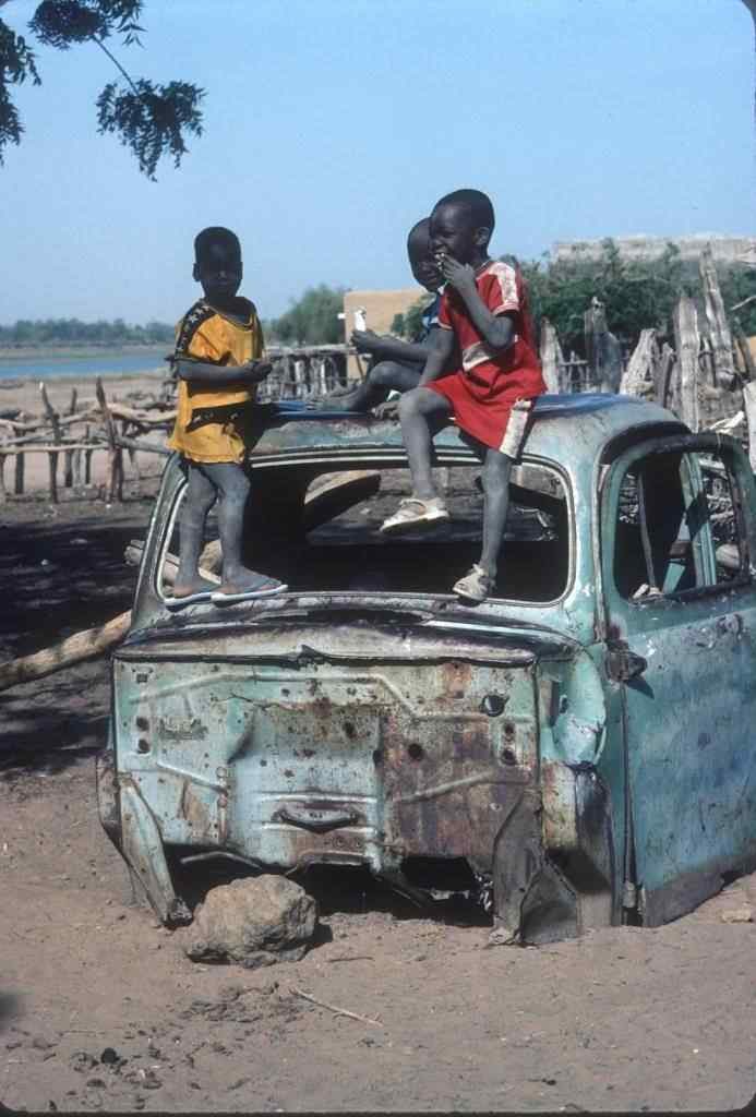 Kids playing on old Citroen used for transport